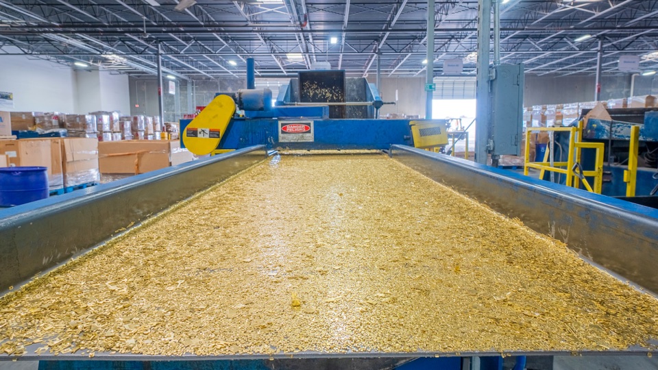 Brass material on a shaker table inside a processing building
