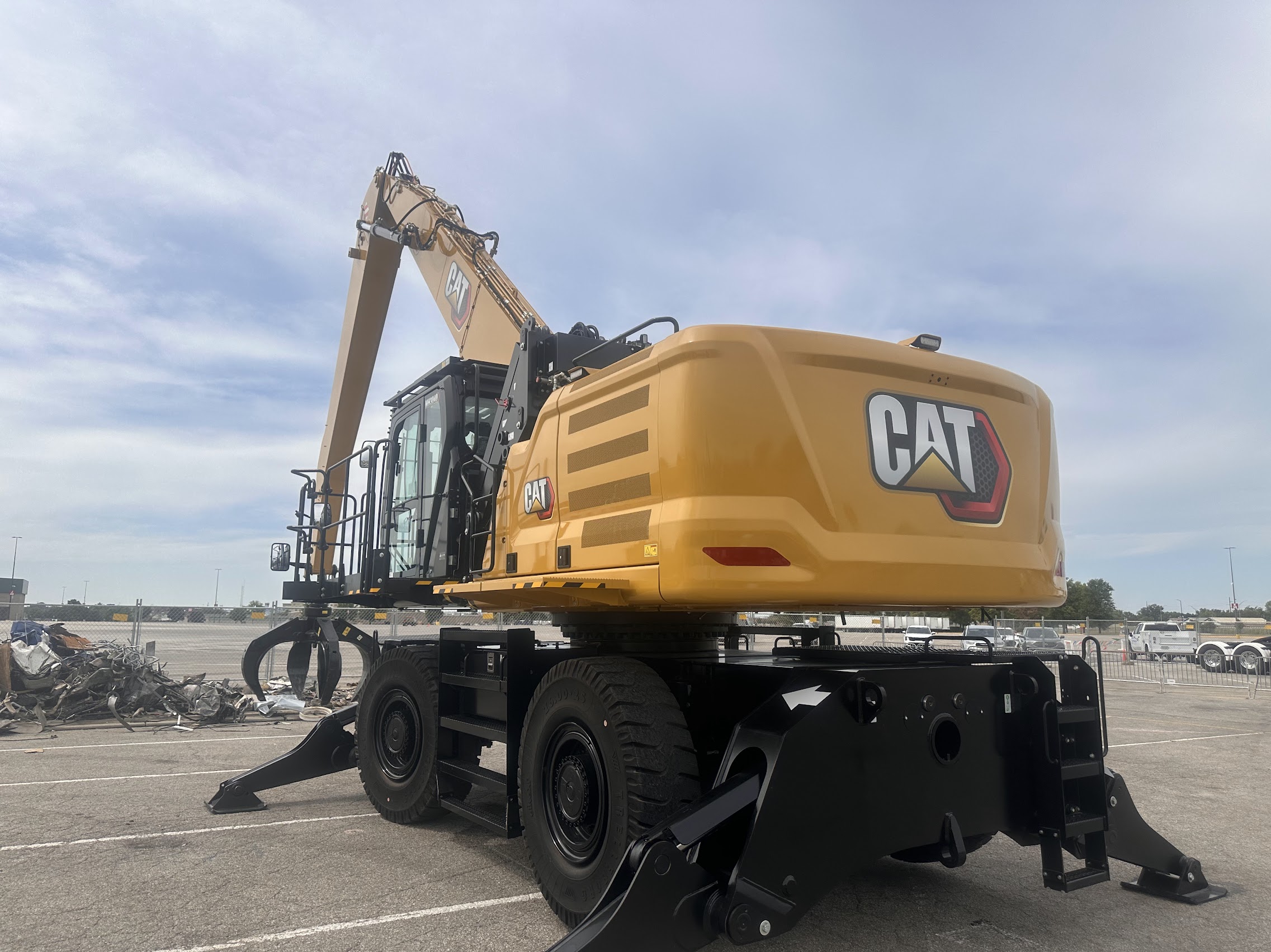 Yellow wheeled material handler at an industrial yard